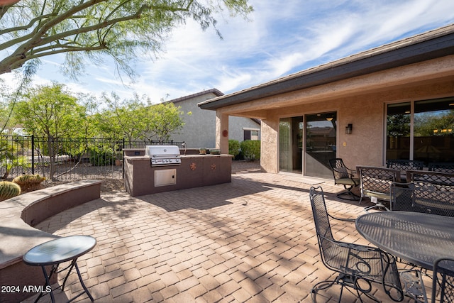 view of patio featuring an outdoor kitchen and area for grilling