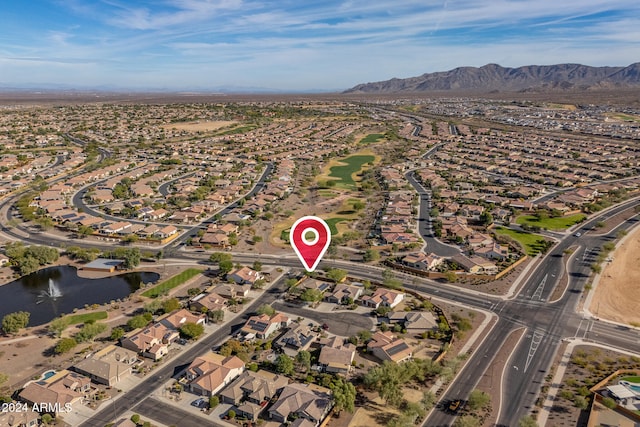 birds eye view of property with a water and mountain view