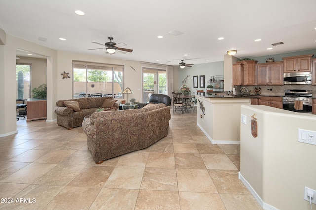 living room featuring ceiling fan and french doors