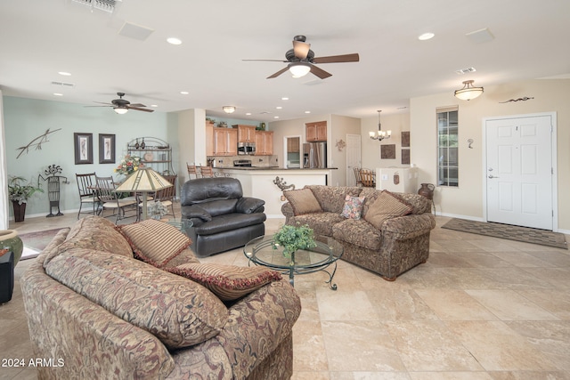 living room with ceiling fan with notable chandelier