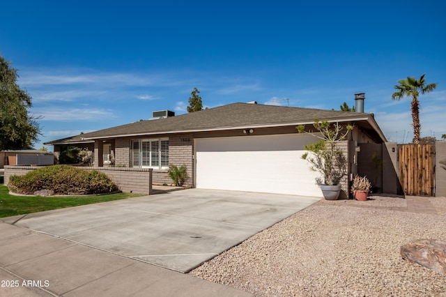 single story home with a garage, concrete driveway, and brick siding