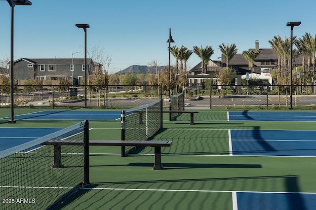 view of tennis court featuring fence