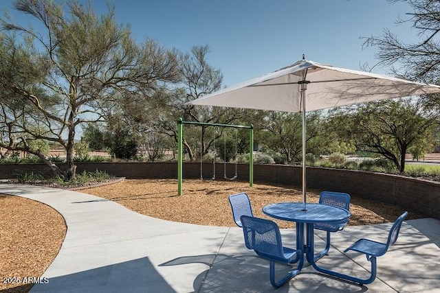 view of patio / terrace with playground community and fence