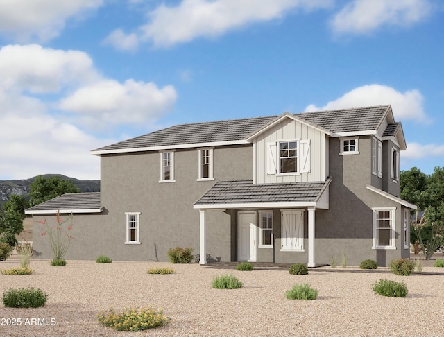 exterior space featuring covered porch, board and batten siding, and stucco siding