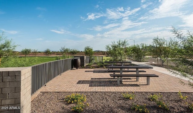 view of home's community with a patio area and fence