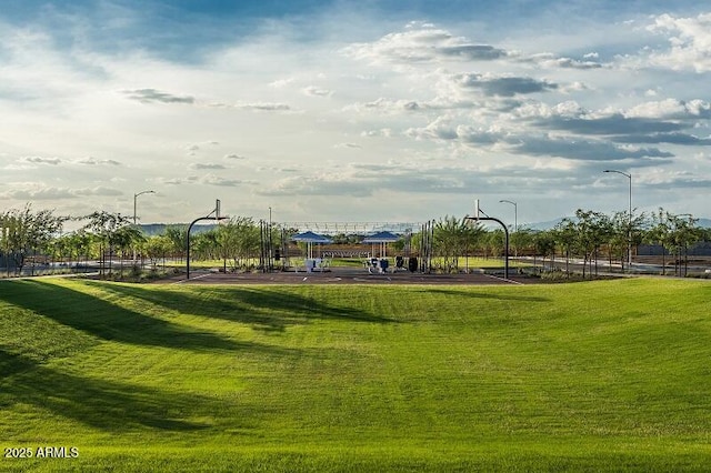 view of property's community featuring community basketball court and a lawn