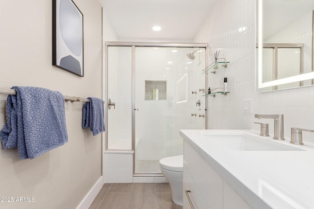 full bath featuring toilet, a stall shower, backsplash, tile walls, and vanity