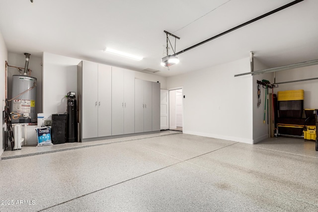 garage with gas water heater, a garage door opener, and baseboards