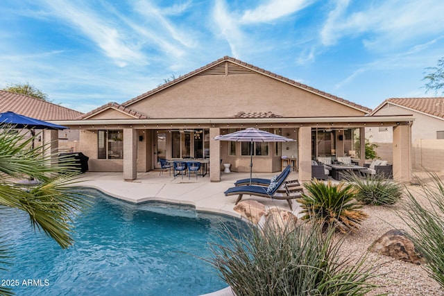 outdoor pool with an outdoor hangout area and a patio