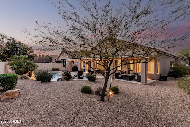 back of property with a patio, fence, a fenced in pool, an outdoor living space, and stucco siding