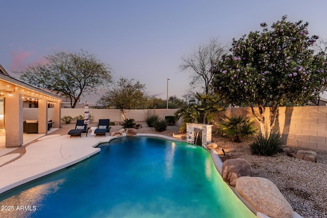 pool at dusk featuring a fenced in pool, a fenced backyard, and a patio area