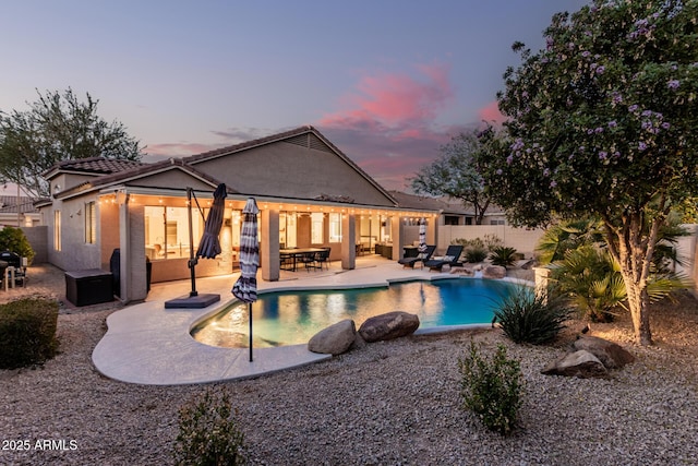 view of swimming pool featuring an outdoor living space, a fenced in pool, a fenced backyard, and a patio area