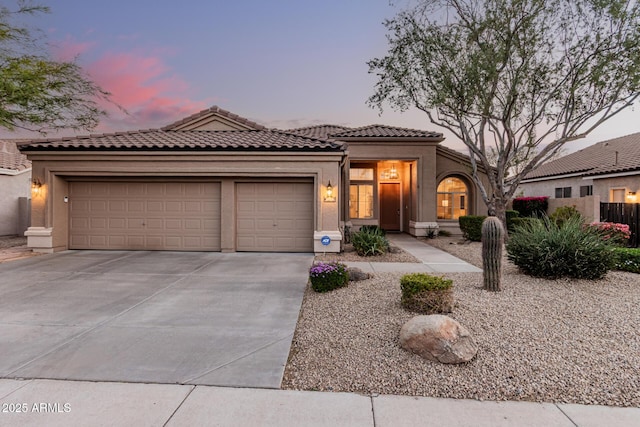 view of front of house featuring fence, driveway, an attached garage, stucco siding, and a tile roof