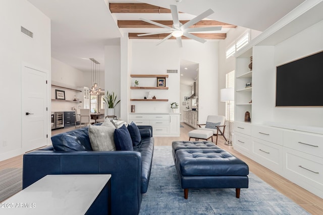 living room featuring visible vents, plenty of natural light, and light wood-style floors