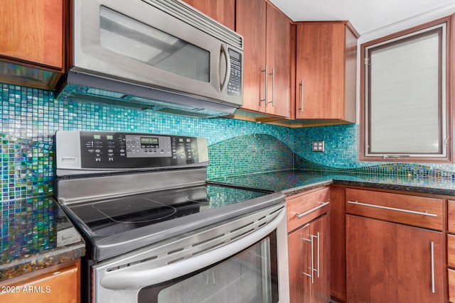 kitchen featuring decorative backsplash, dark stone countertops, and stainless steel appliances