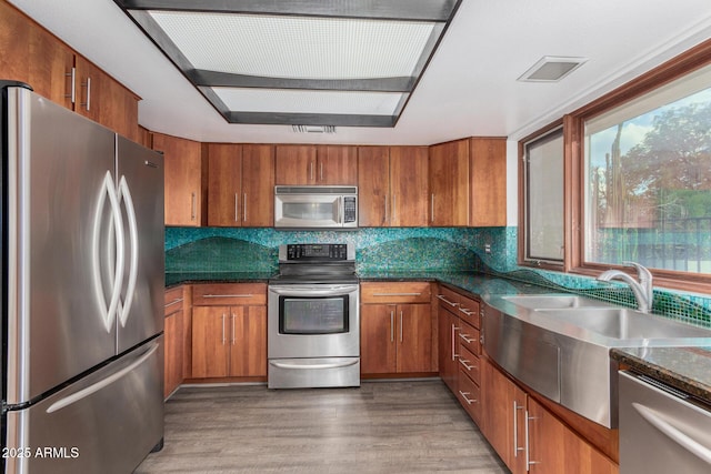 kitchen featuring tasteful backsplash, dark wood-type flooring, sink, and stainless steel appliances