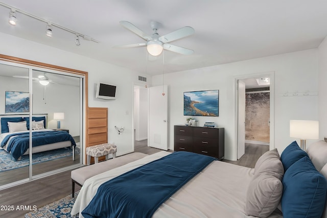 bedroom with ceiling fan, ensuite bath, a closet, and wood-type flooring