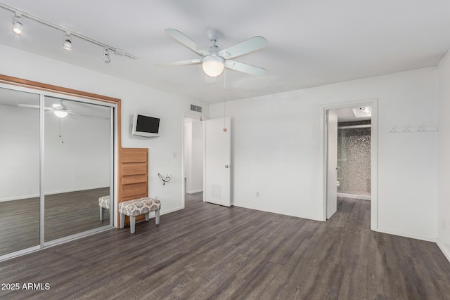 unfurnished bedroom with ceiling fan, dark wood-type flooring, and a closet