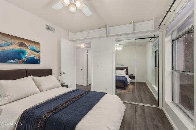 bedroom with ceiling fan, a closet, and dark hardwood / wood-style flooring