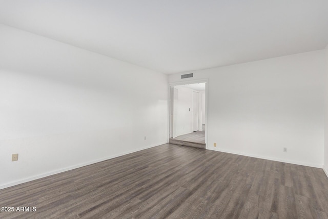 unfurnished room featuring dark hardwood / wood-style flooring