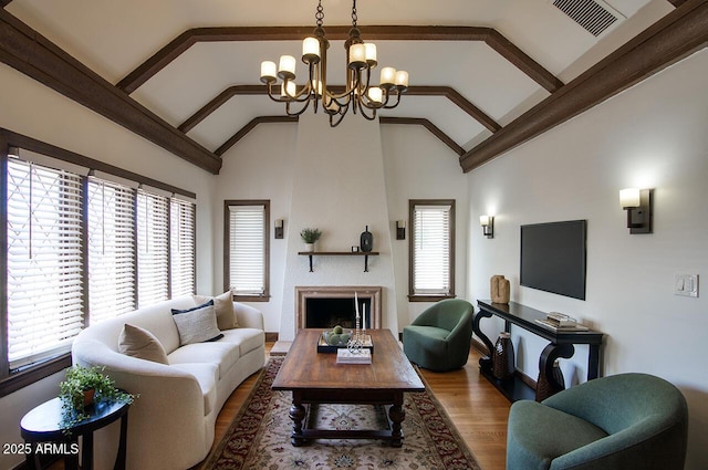 921 W Willetta St, Phoenix, AZ 85007 - living area featuring a chandelier, wood finished floors, high vaulted ceiling, baseboards, and a large fireplace