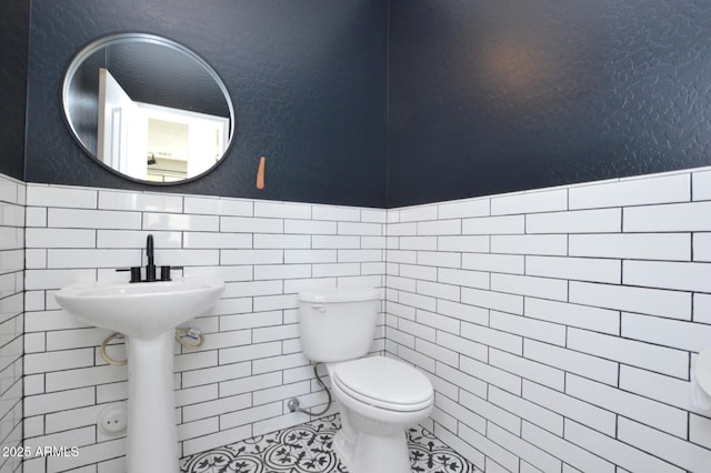 20258 S 196th St, Queen Creek, AZ 85142 - half bath featuring a wainscoted wall, tile walls, and tile patterned flooring