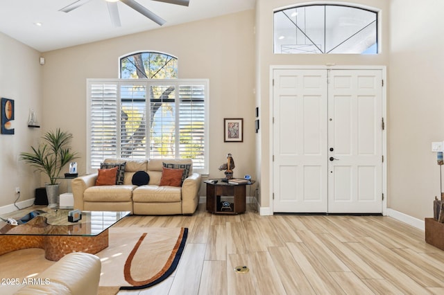 entryway with light hardwood / wood-style floors, lofted ceiling, and ceiling fan