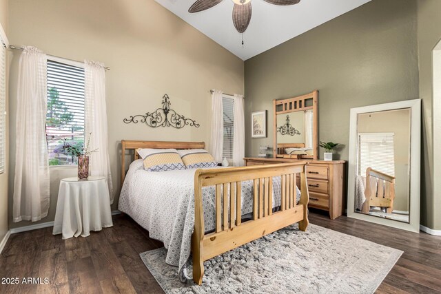 bedroom featuring high vaulted ceiling, dark wood-type flooring, baseboards, and a ceiling fan