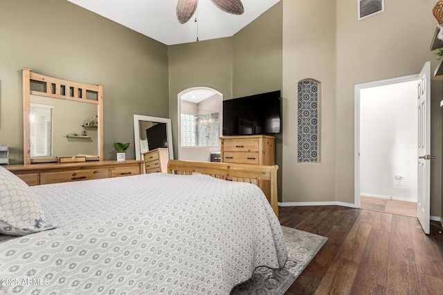 bedroom featuring dark wood-style floors, high vaulted ceiling, baseboards, and ceiling fan