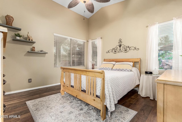 bedroom featuring dark wood-style floors, baseboards, a ceiling fan, and high vaulted ceiling