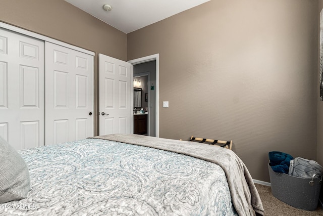 carpeted bedroom featuring a closet and baseboards