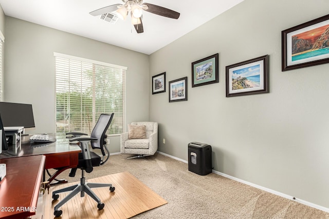 carpeted home office featuring a ceiling fan and baseboards