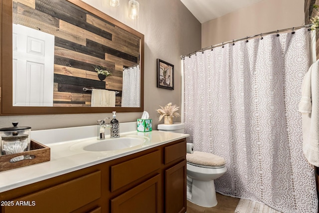 bathroom with vanity, toilet, and curtained shower