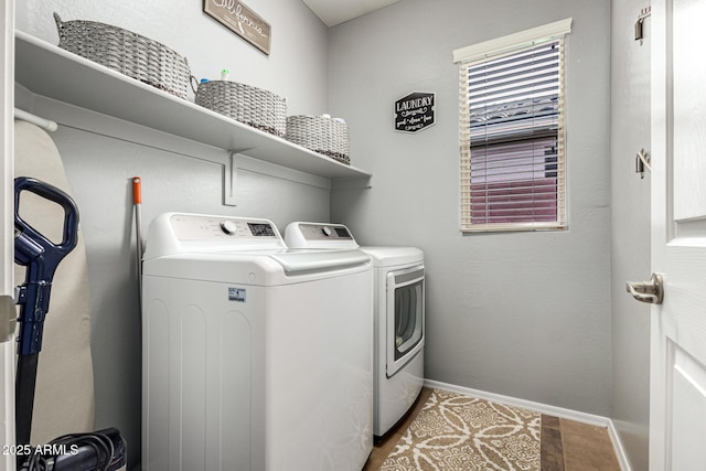 clothes washing area with washer and clothes dryer, baseboards, and tile patterned floors