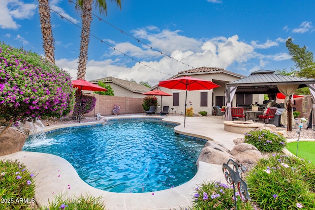 view of swimming pool with a patio area, a gazebo, and a fenced backyard