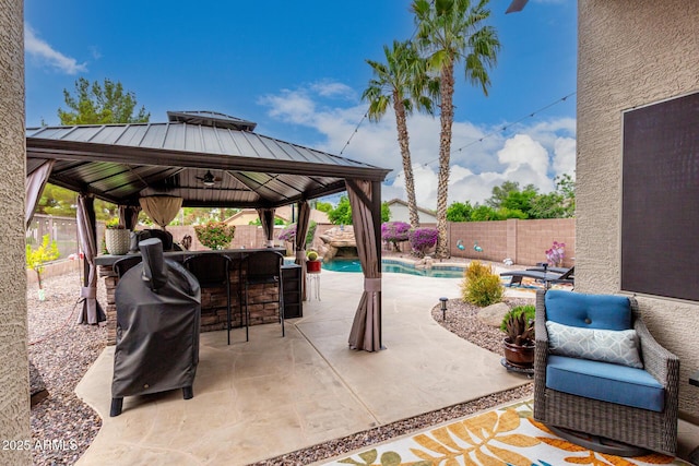 view of patio / terrace with a gazebo, a fenced backyard, and grilling area