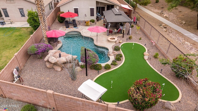 view of swimming pool featuring a gazebo, a putting green, a fenced backyard, and a patio area