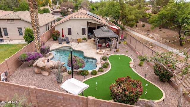 view of pool with a gazebo, a putting green, and a fenced backyard