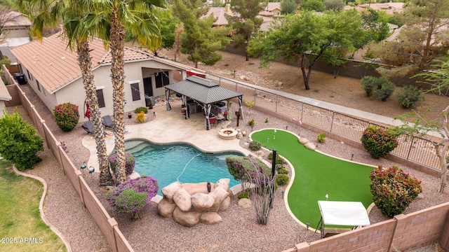 view of pool with an area to practice putting, a gazebo, a fenced backyard, and a patio area
