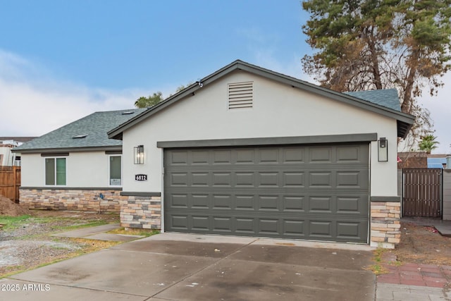 single story home with a garage, fence, stone siding, roof with shingles, and stucco siding