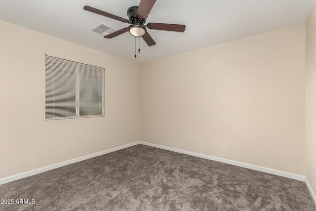 spare room featuring carpet, visible vents, ceiling fan, and baseboards