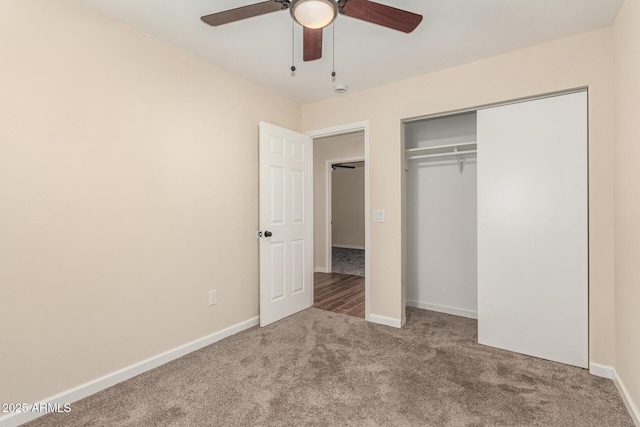 unfurnished bedroom featuring a closet, carpet, a ceiling fan, and baseboards