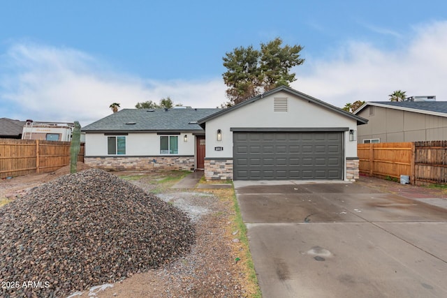 ranch-style house with concrete driveway, fence, an attached garage, and stucco siding