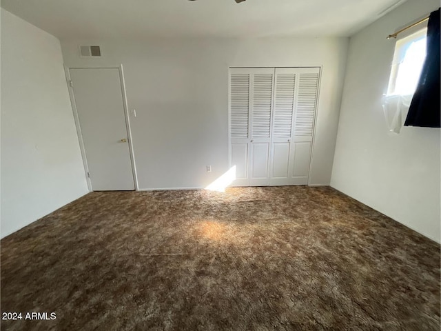 unfurnished bedroom with carpet and a closet