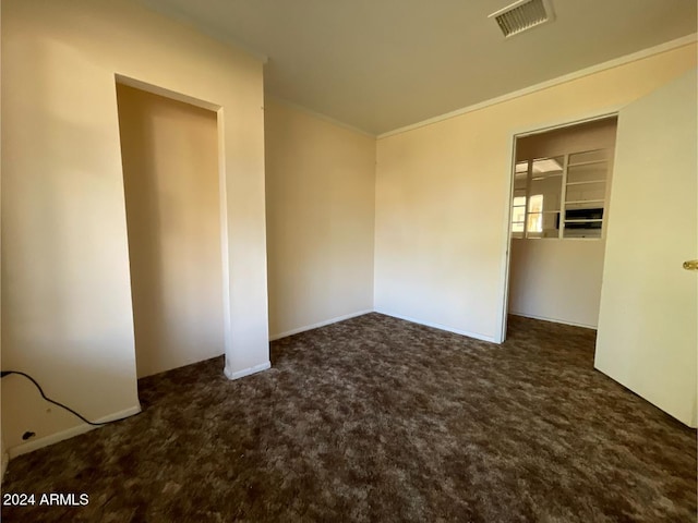 empty room with dark carpet