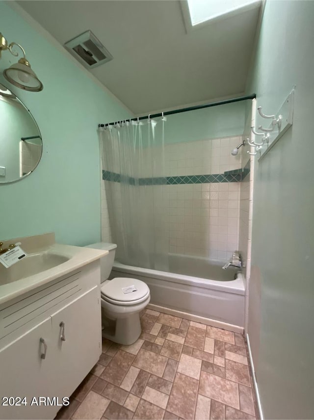 full bathroom featuring shower / bath combo, vanity, and toilet