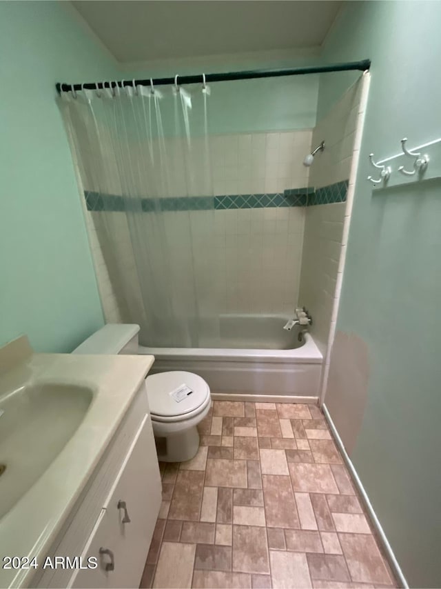 full bathroom with tiled shower / bath combo, toilet, and vanity