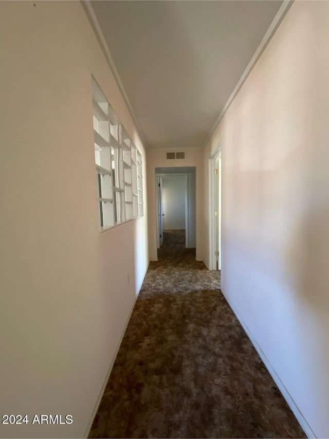 hallway featuring carpet flooring and ornamental molding