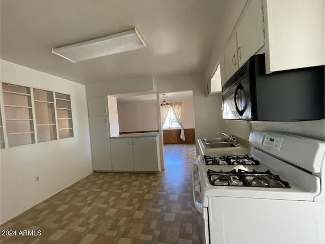 kitchen with white cabinets, white gas range, sink, and a chandelier