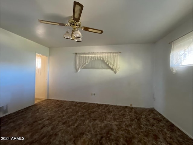 unfurnished room featuring ceiling fan and carpet floors